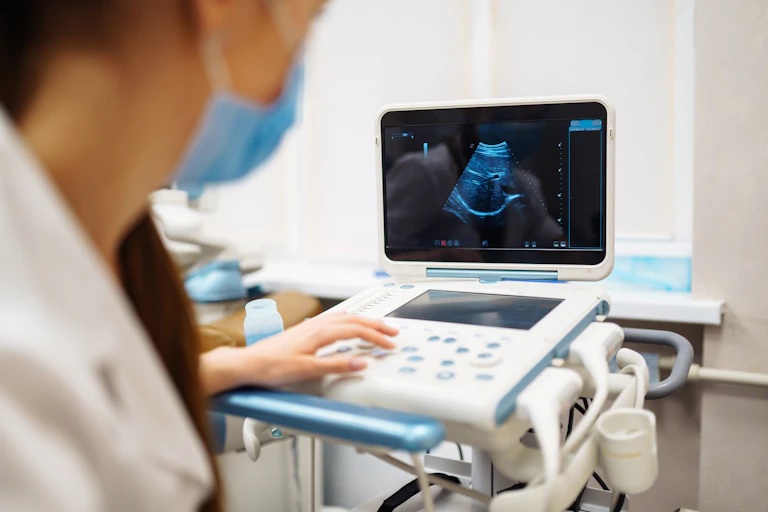 A doctor looking at an ultrasound on a screen