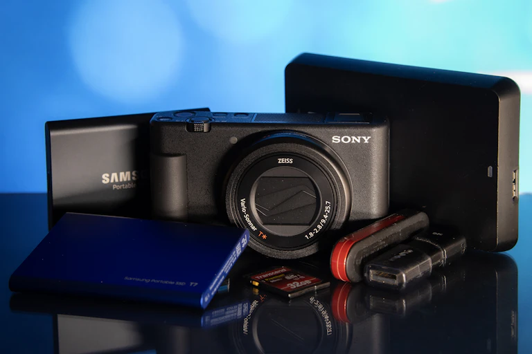 A camera and several electronic devices piled together