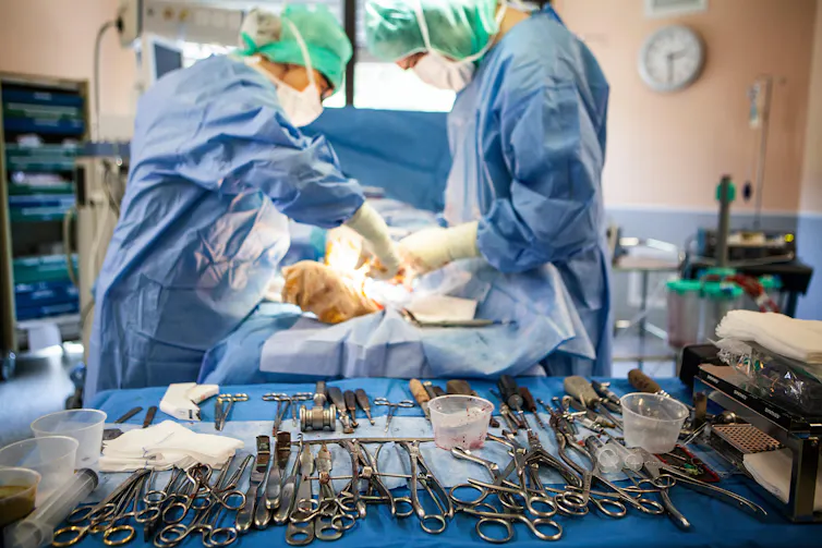 Orthopoedic surgeons in an operating theatre.
