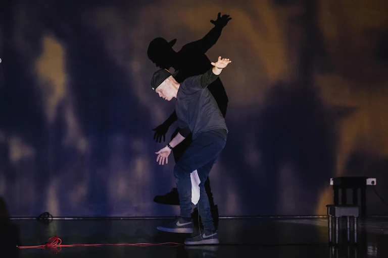 A man on stage wearing all black