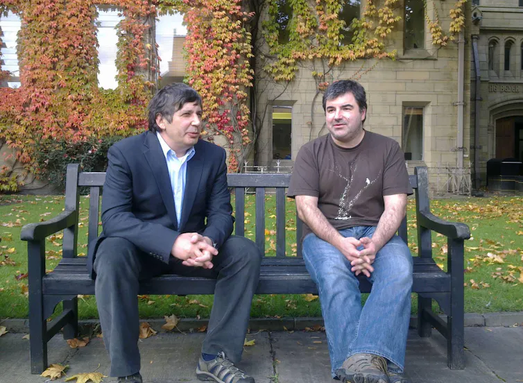 Andre Geim and Konstantin Novoselov on a bench in 2010