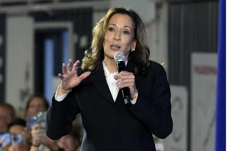 A woman holds a microphone in front of a crowd