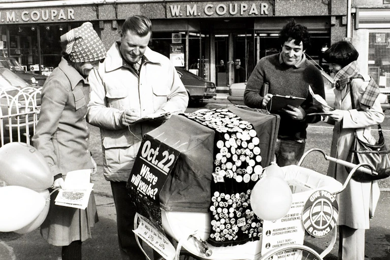 Photo of a pram covered in CND badges