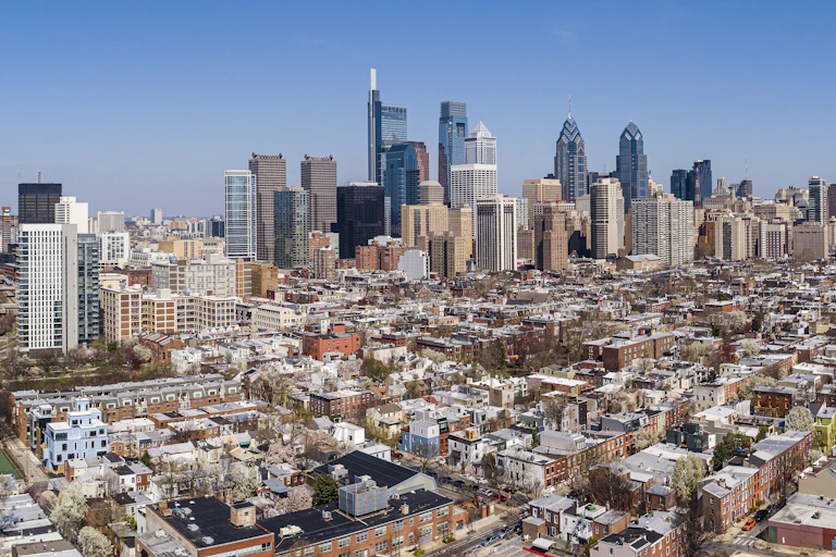 Aerial view of large city with skyscrapers and residential housing
