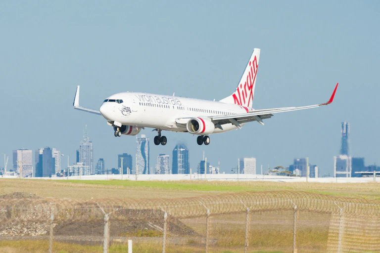 Plane seen landing in front of Melbourne skyline