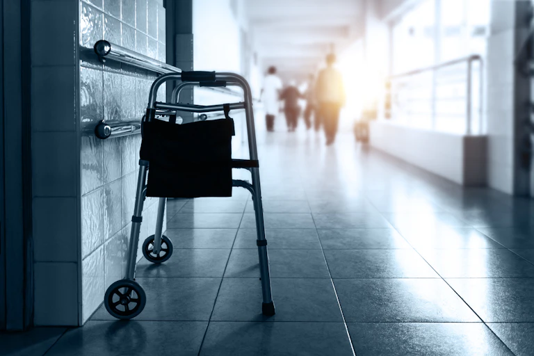 Metal rollator parked in care home hallway
