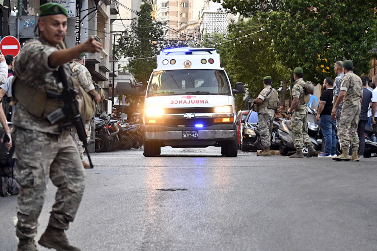 Ambulance and soldiers on a crowded street