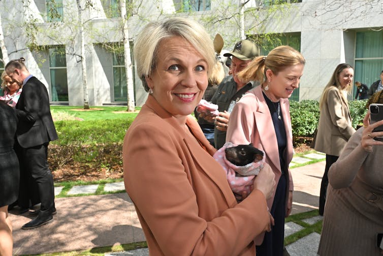 woman holding baby tassie devil