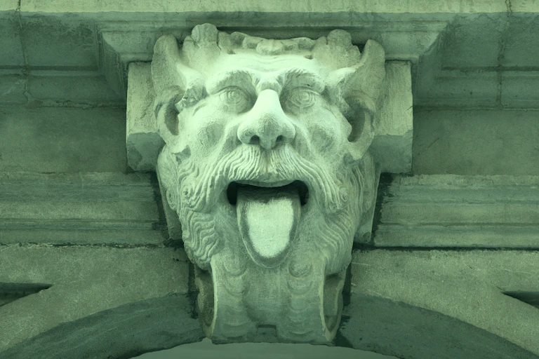 A gargoyle head sticking out his tongue.