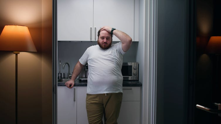 Man stands in kitchenette