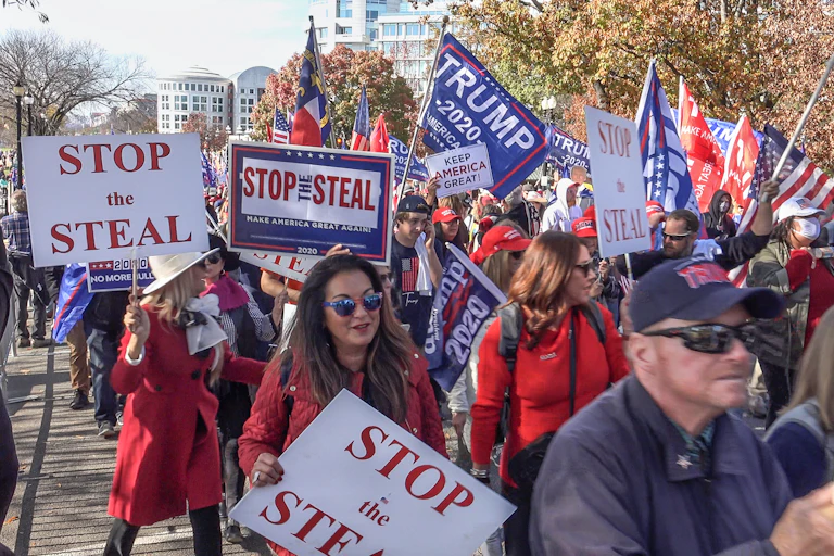 Trump supporters holding signs saying "stop the steal" after the 2020 election.