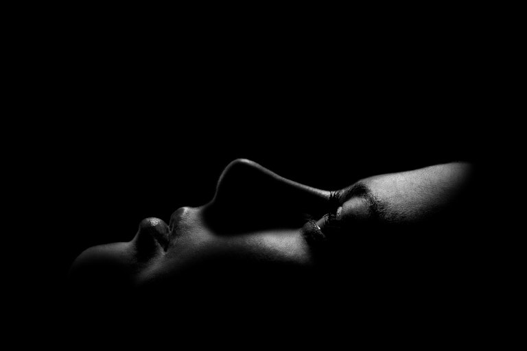 Black and white photo of a young woman's face looking upwards