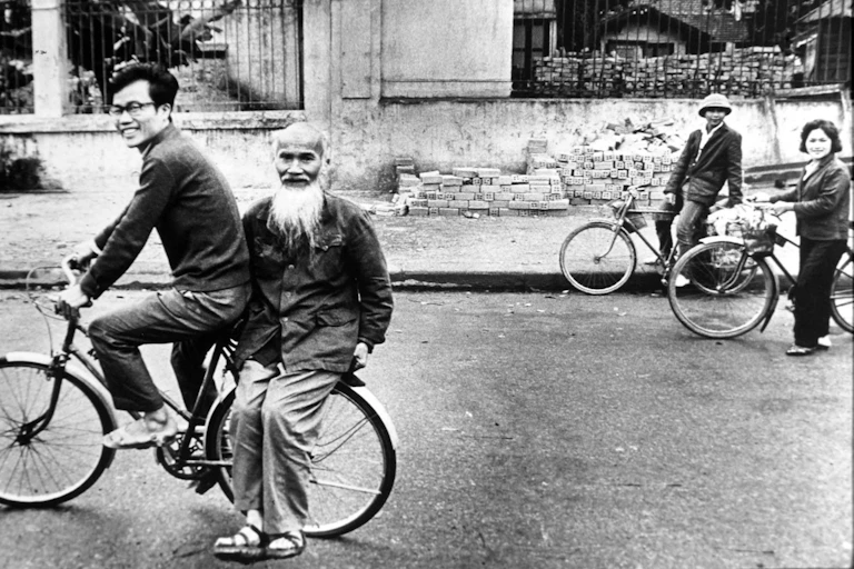People on bicycles in a street.