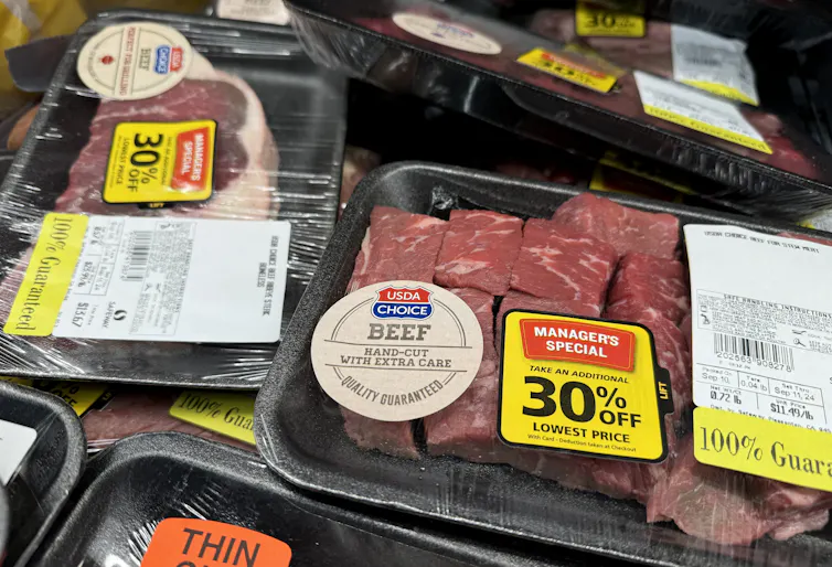 Meat sold at a 30% discount is displayed at a grocery store .