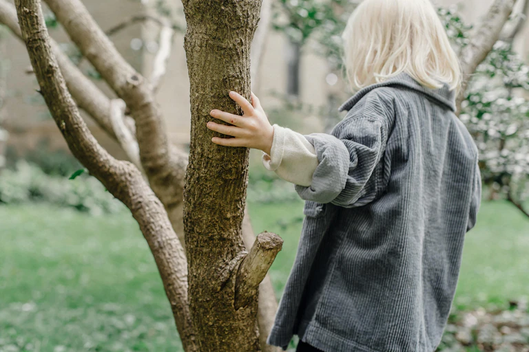 Child holds a tree while having a panic attack