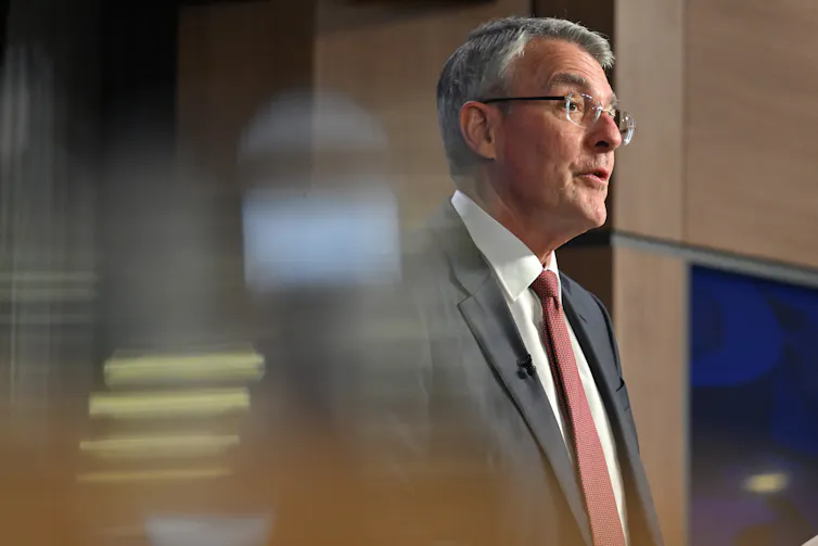 A man speaks to a room.