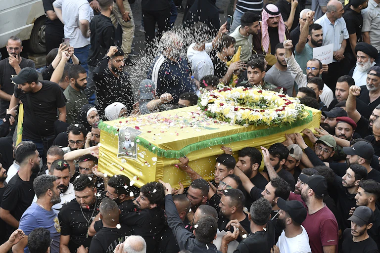 A crowd of people surround the coffin of a victim of the September 17 pager attack in Beirut.