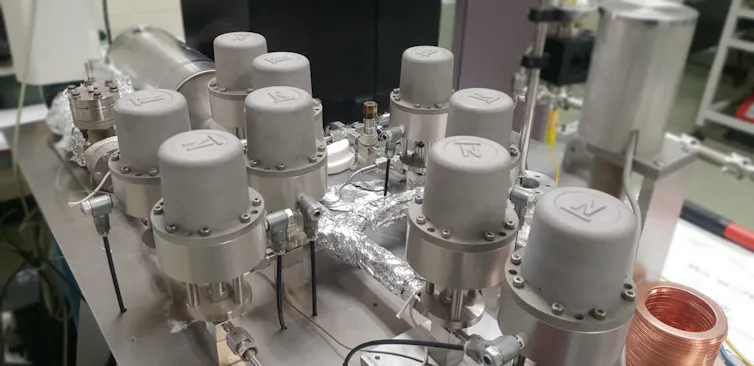 Photo of lab equipment consisting of multiple grey containers.