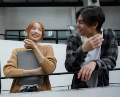 Two people seen in conversation.