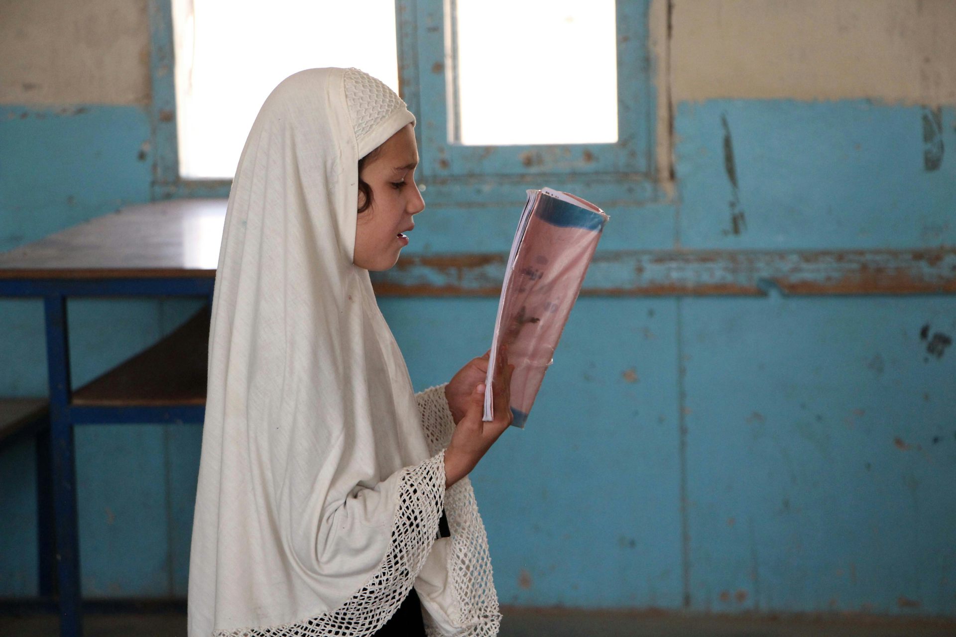 A girl reading in a classroom