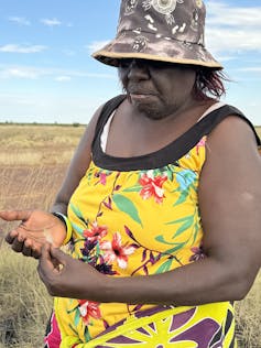 Indigenous woman holds feather