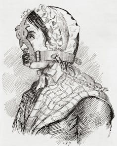 A black and white historical illustration of a woman in a cap and shawl with a metal muzzle fitted over her head and around her mouth so that she cannot talk.