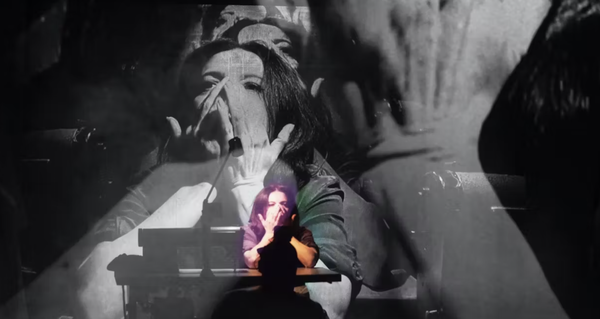 Woman on stage covering her face