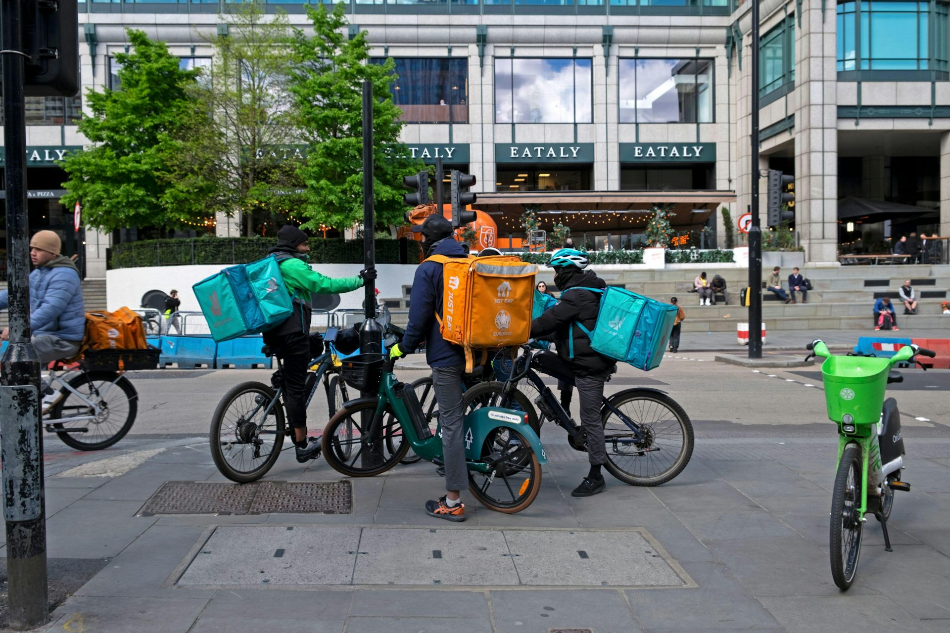 Three food couriers on their bicycles