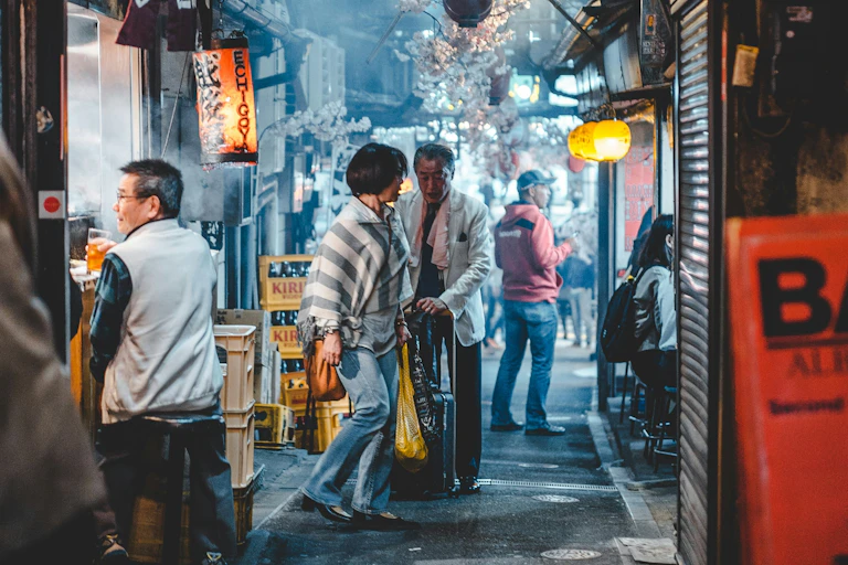 An older Japanese couple in a laneway.