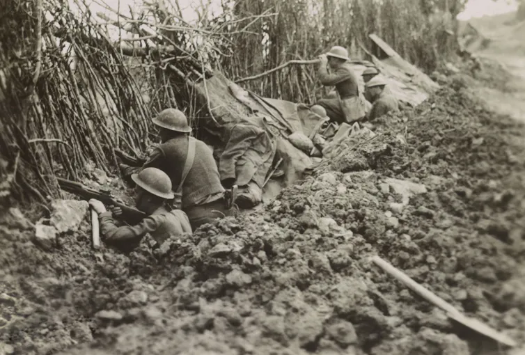 American soldiers crouched in a trench in the first world war.
