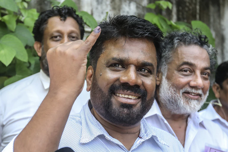 Anura Kumara Dissanayake holding his ink-marked finger up to the camera.