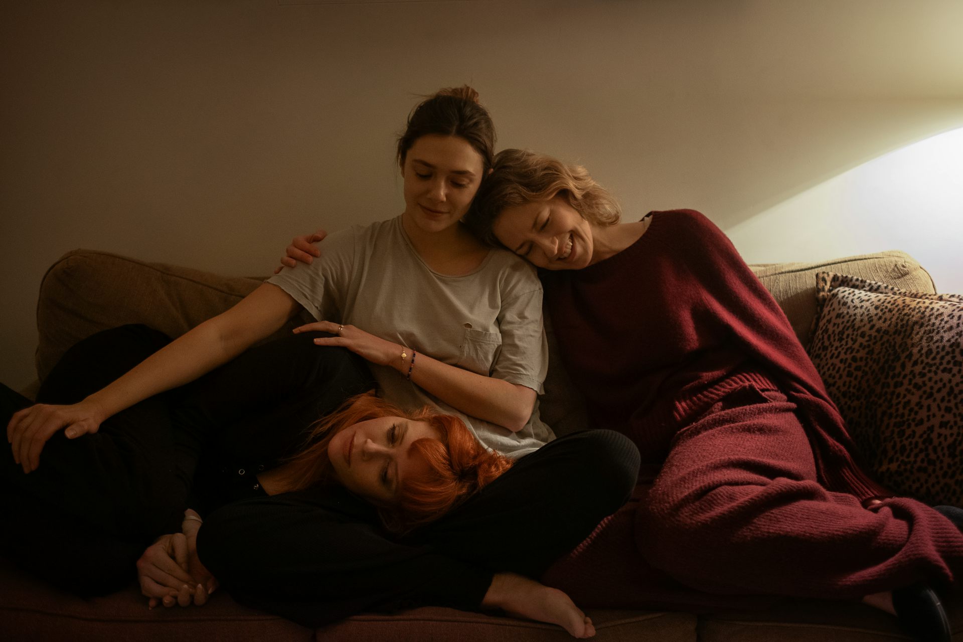 The three sisters sitting together on a sofa.