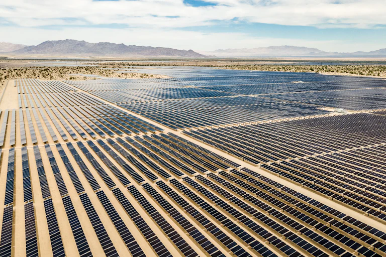 Large arrays of solar panels on desert land