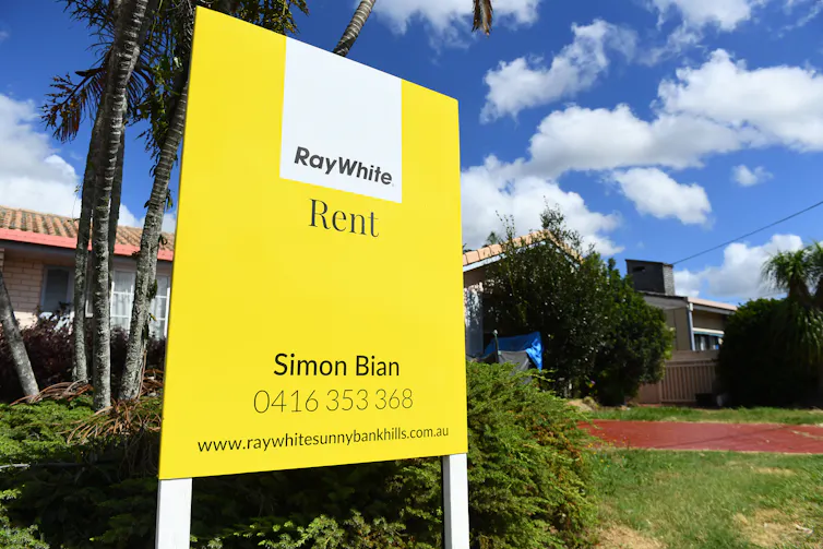 Bright yellow rental sign in front of a home.