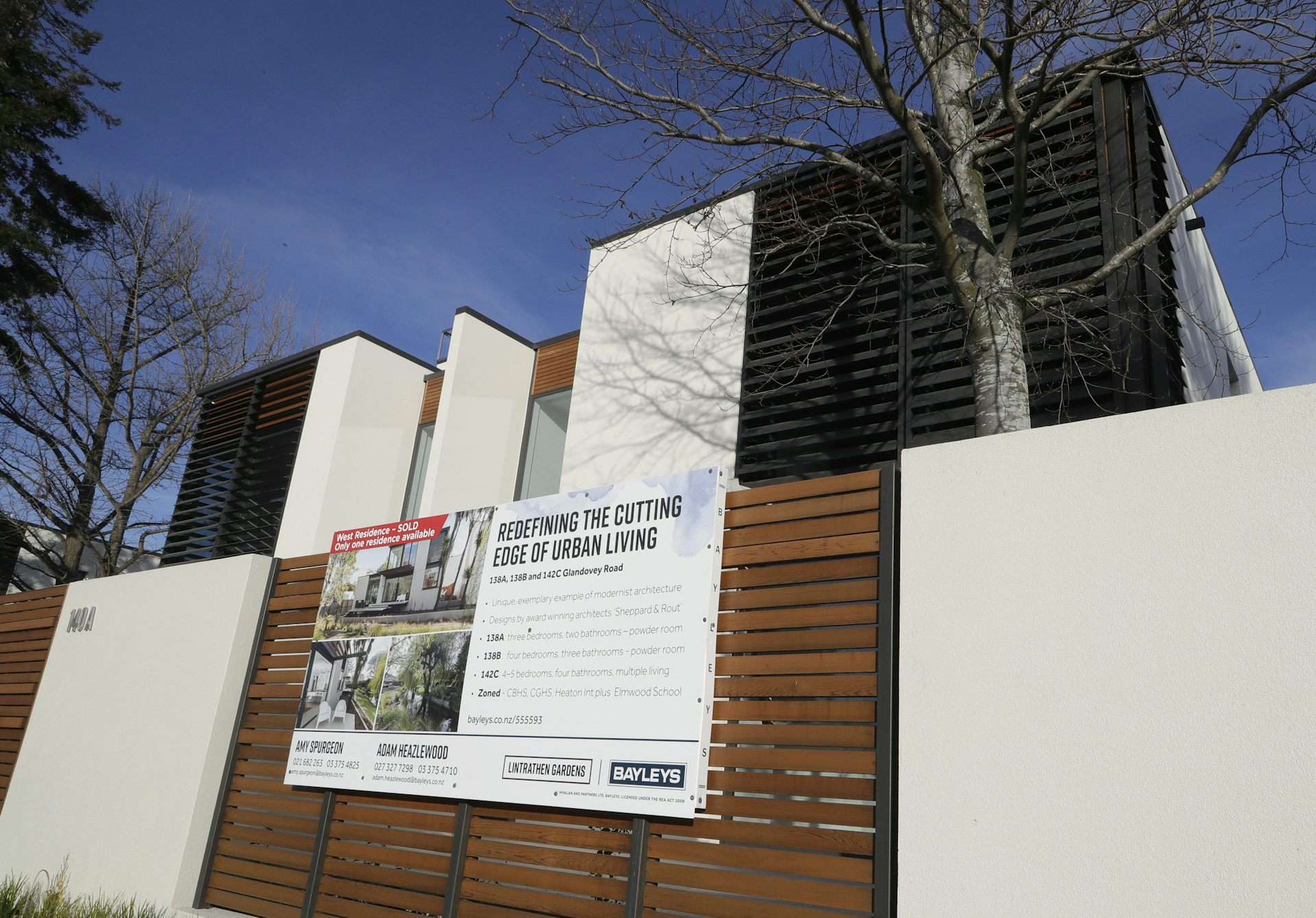 A house with an auction board on the fence
