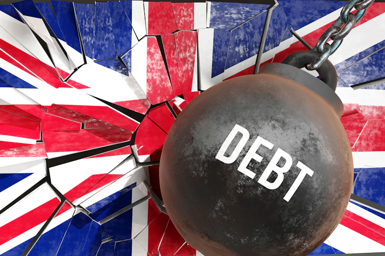 Wrecking ball labelled 'debt' smashing into Union Jack.