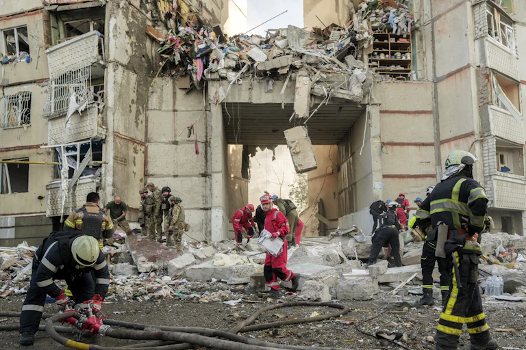 Firefighters and rescue workers sift through rubble at the site of a shelling on a high-storey residential building in Kharkiv, northeastern Ukraine, 24 September 2024.