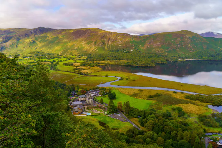 Meandering river flows through large wide valley
