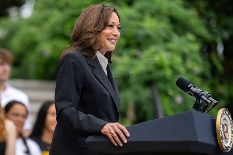 Kamala Harris stands at a podium to make a speech at the White House.