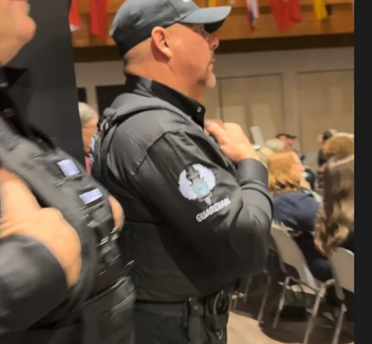 a man stands wearing all black