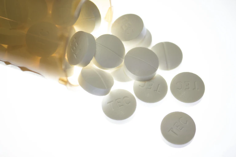 Pills spilling out of a pill bottle