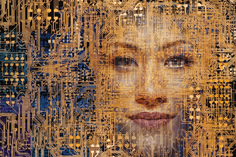 A woman's face appears within a network of computer circuitry.