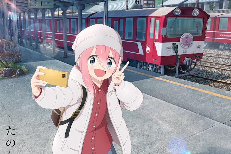 A smiling girl holding a phone and doing a selfie.