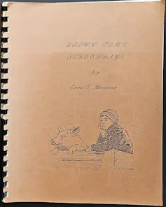 The cover of a spiral bound book, with illustration of a boy in a cap.