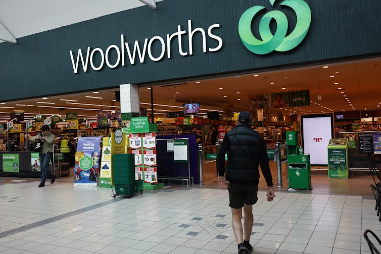 A person walks into a Woolworths store.