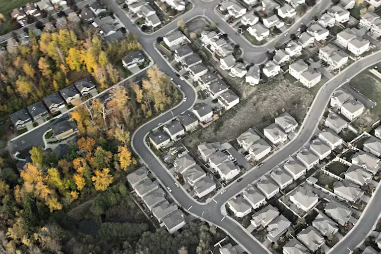Aerial view of houses, some of them pictured in black and white
