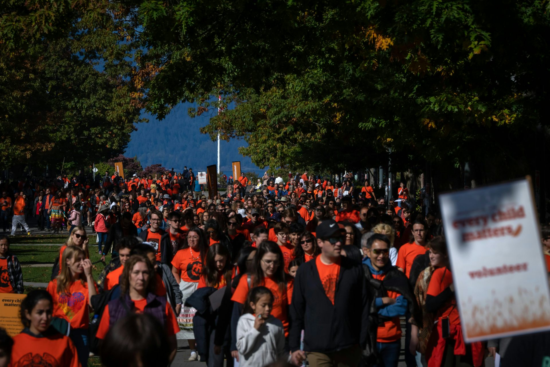 People at a rally in orange shirts.