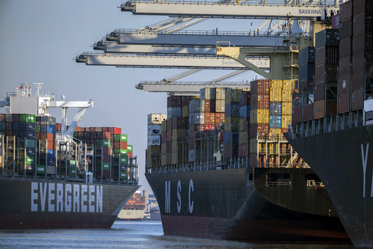 Colorful containers are aboard ships in a port.