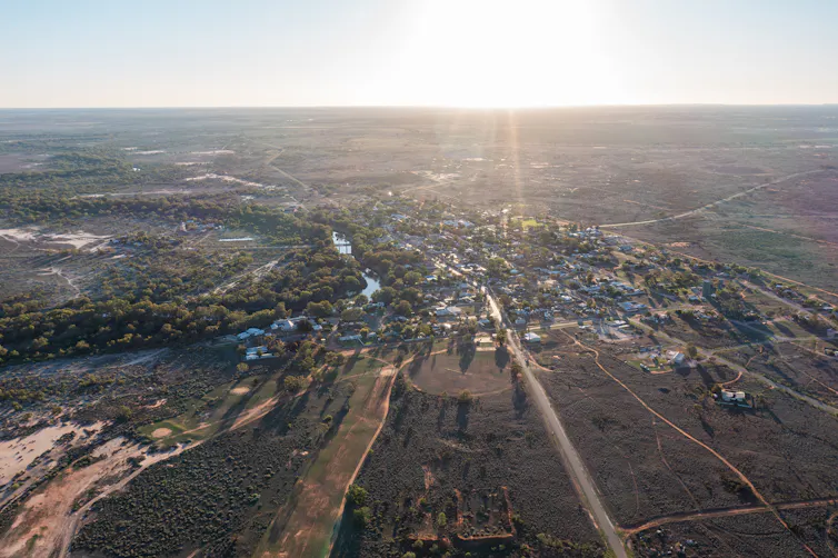 aerial view of town with river winding through it