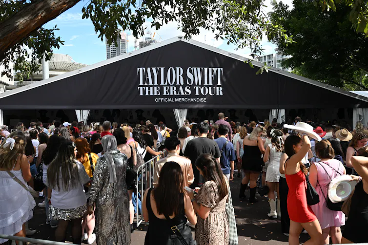 Concertgoers wait in line to get their tickets scanned.